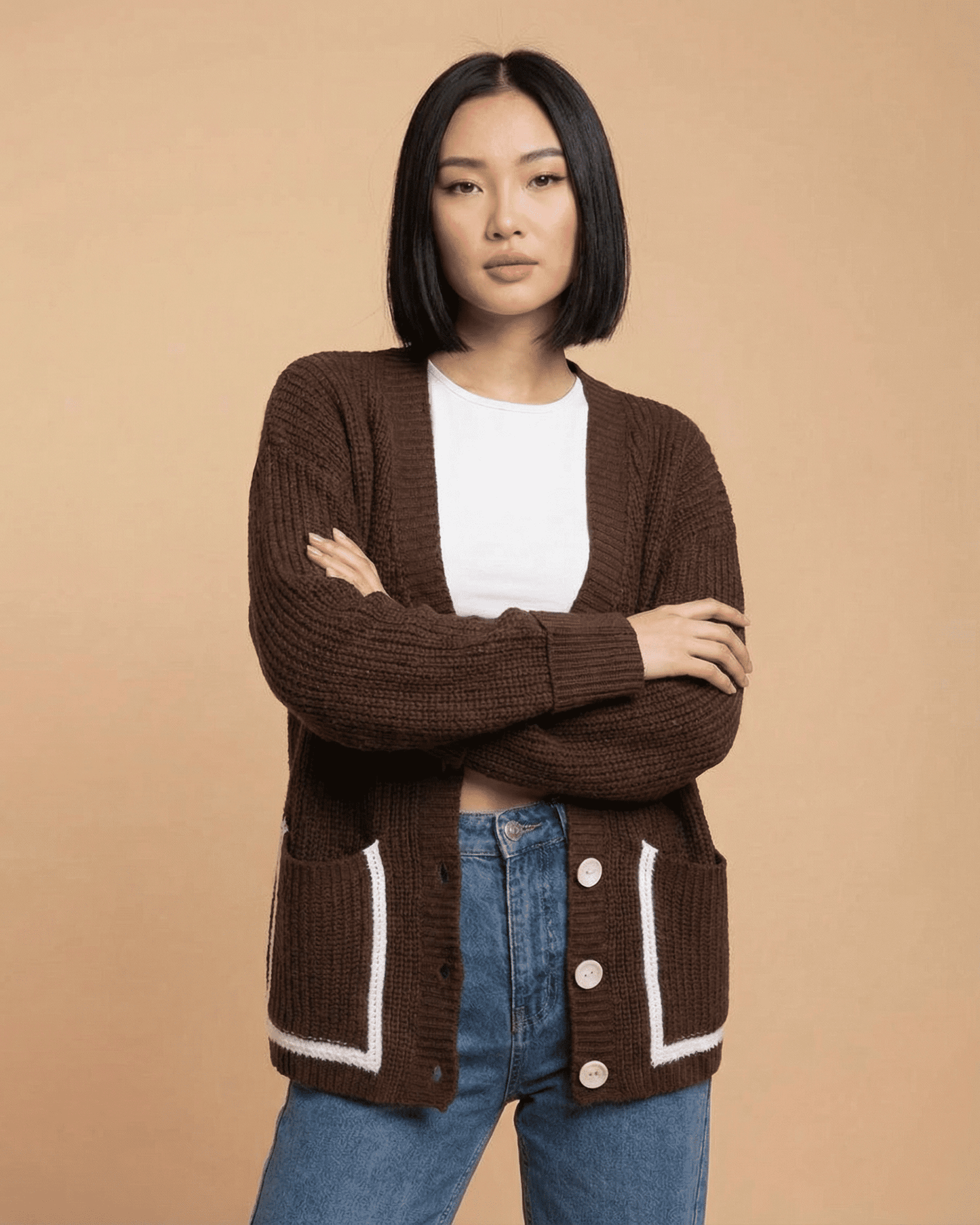 Model wearing a Cocoa Cardigan by SLIMONA, featuring a relaxed fit, V-neckline, and color block design.