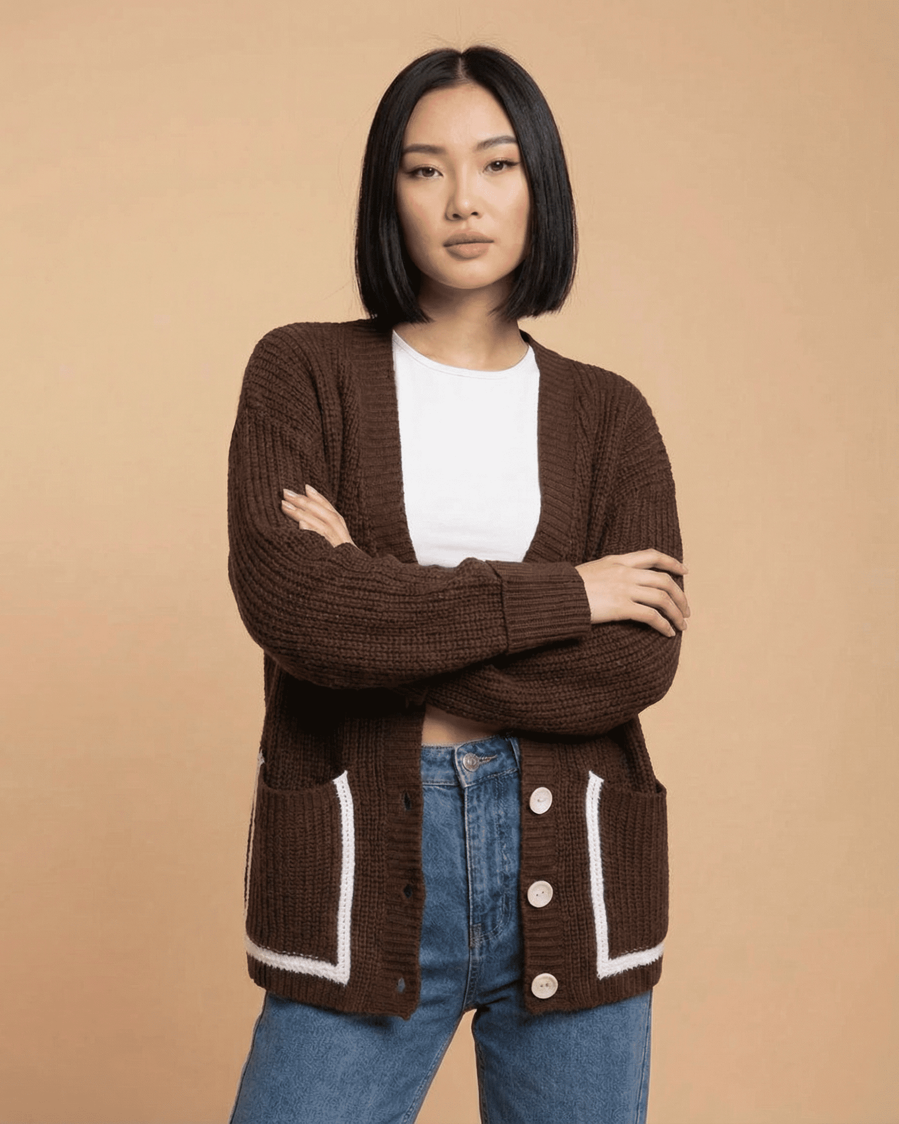 Model wearing a Cocoa Cardigan by SLIMONA, featuring a relaxed fit, V-neckline, and color block design.
