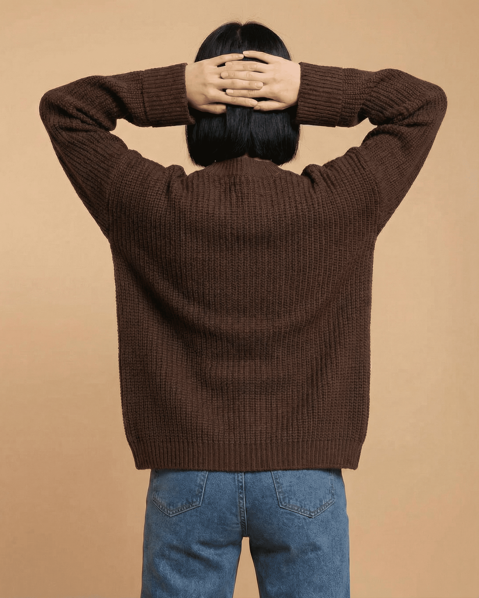 Back view of a model wearing the Cocoa Cardigan by SLIMONA, showcasing its relaxed fit and textured knit design.