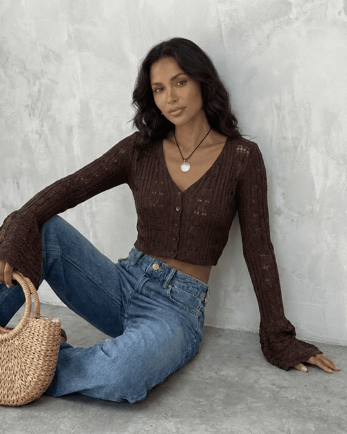 Model wearing a Cocoa Cardigan by SLIMONA, showcasing its cropped design and flare sleeves.