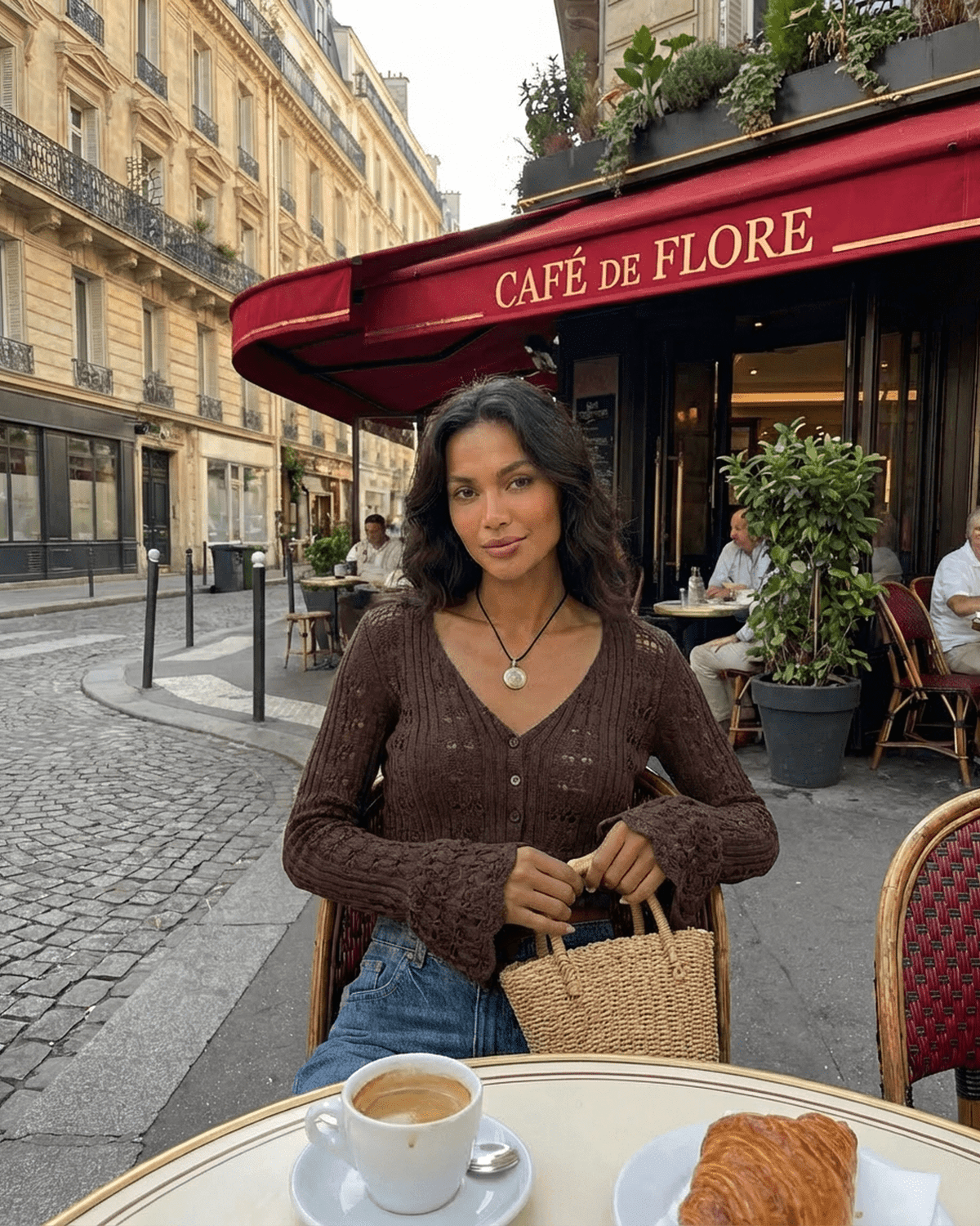 Cocoa Cardigan by SLIMONA worn at Café de Flore, showcasing a relaxed Parisian vibe with coffee and pastry.