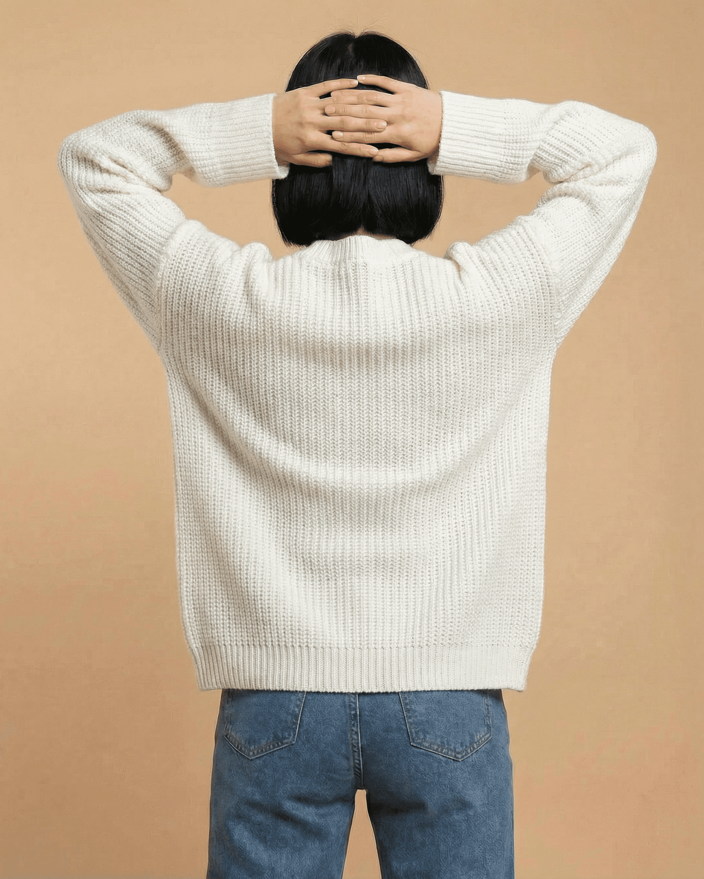 Elara Cardigan by SLIMONA – Loose fit V-neck knit sweater in cream color from the back.