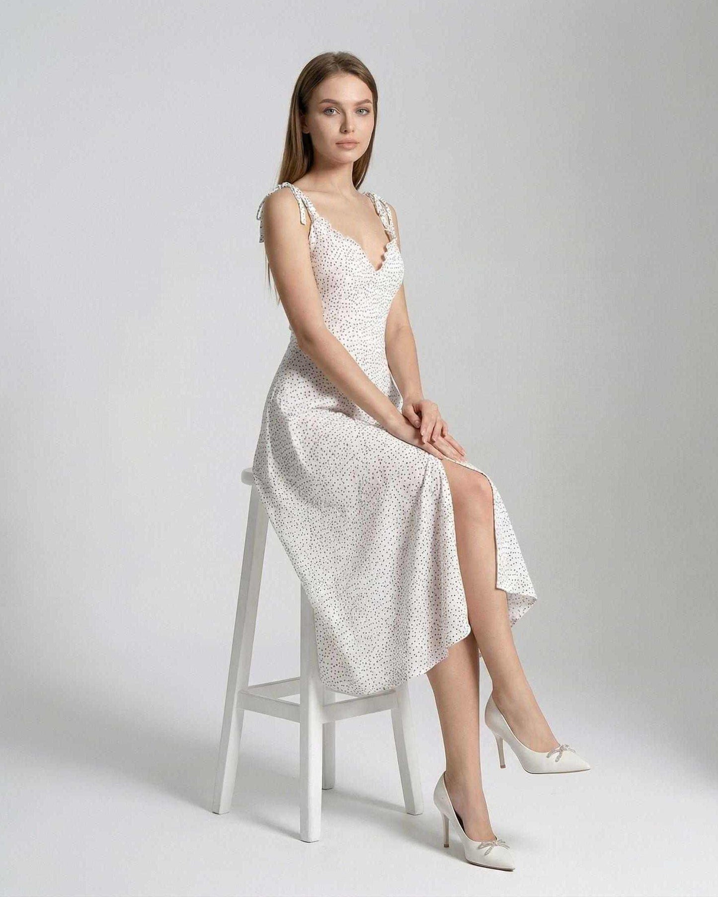 Elara Midi Dress by Lauven, featuring a sleeveless A-line silhouette and elegant polka dot detail.