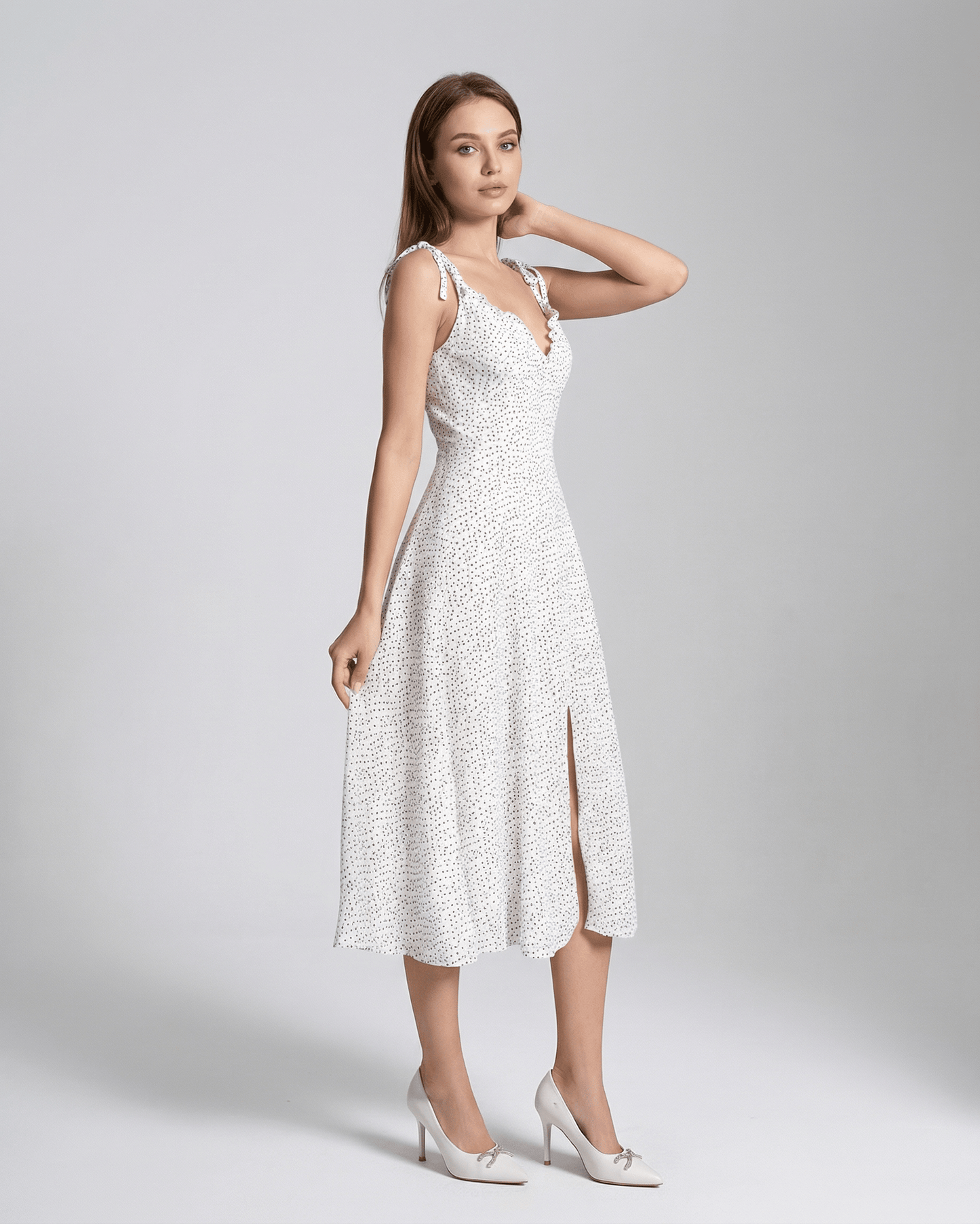 Elara Midi Dress by Lauven featuring a sleeveless A-Line silhouette with a polka dot pattern and flattering high waist.
