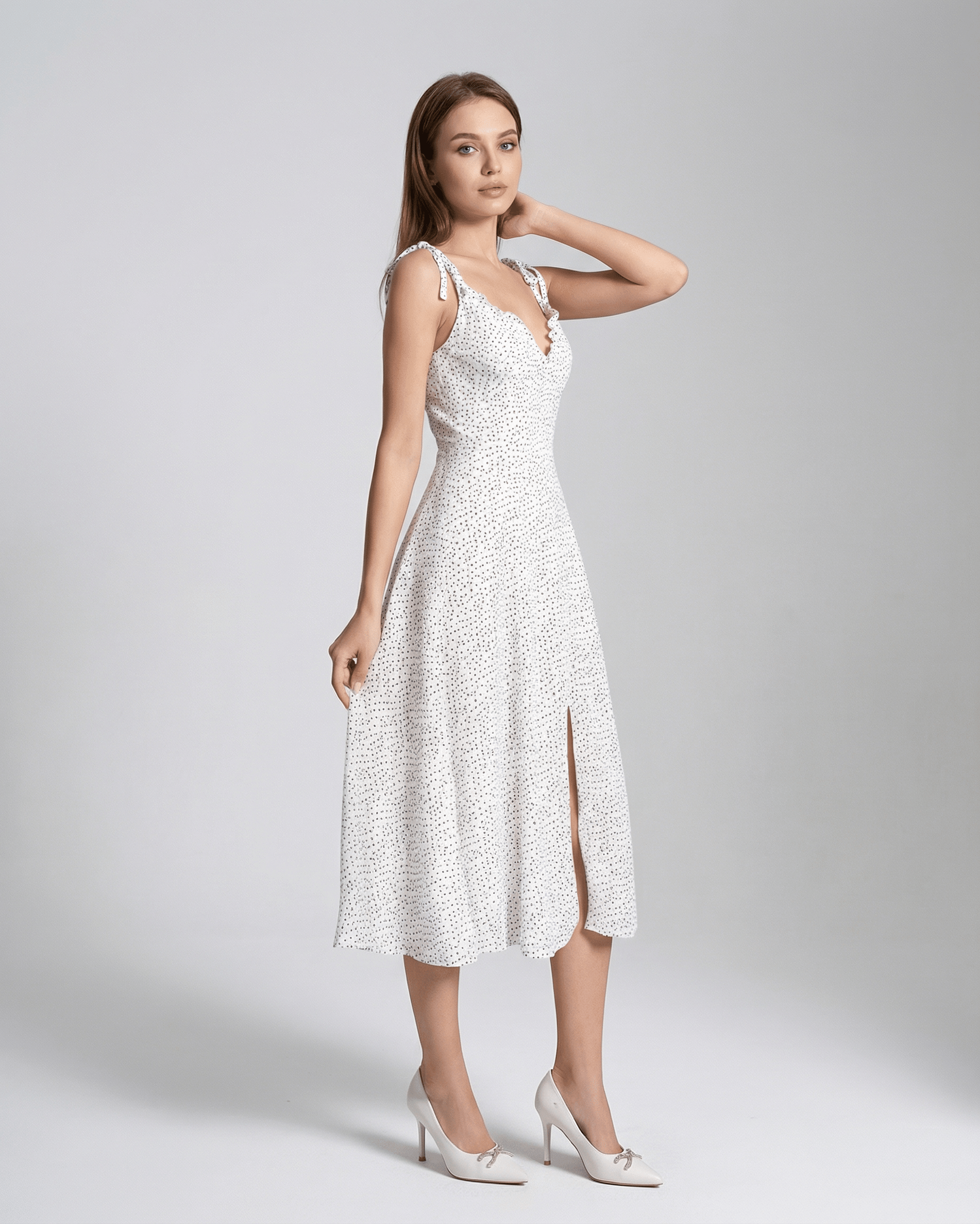 Elara Midi Dress by Lauven featuring a sleeveless A-Line silhouette with a polka dot pattern and flattering high waist.