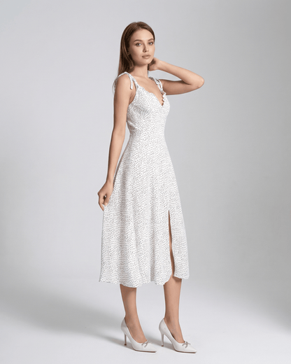 Elara Midi Dress by Lauven featuring a sleeveless A-Line silhouette with a polka dot pattern and flattering high waist.