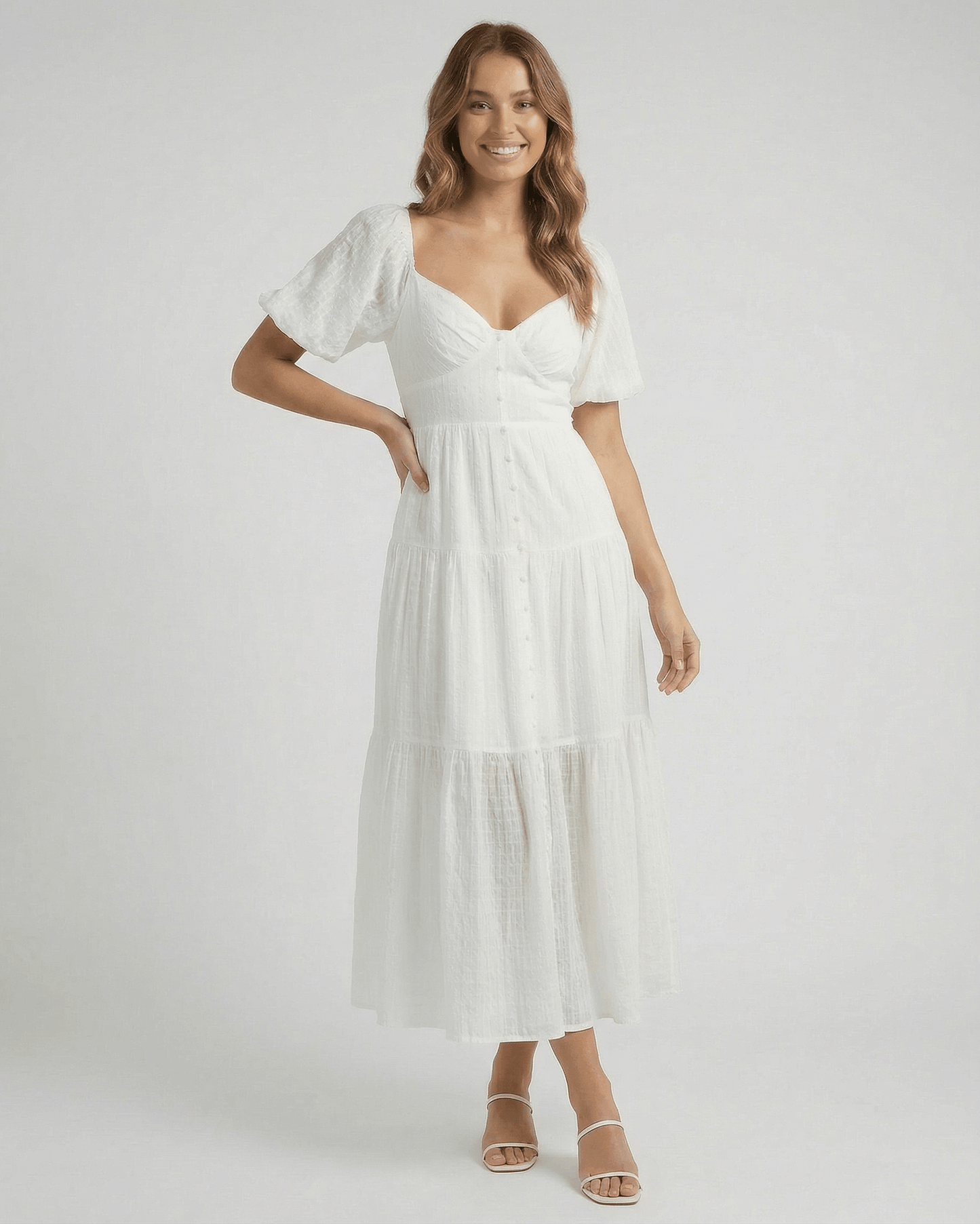 Elara Midi Dress by Lauven – Elegant white A-line silhouette with puff sleeves and button detailing.