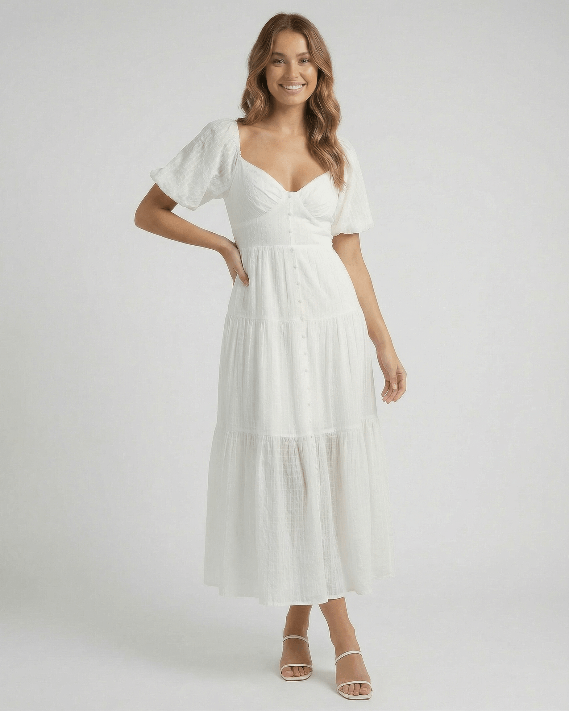 Elara Midi Dress by Lauven – Elegant white A-line silhouette with puff sleeves and button detailing.