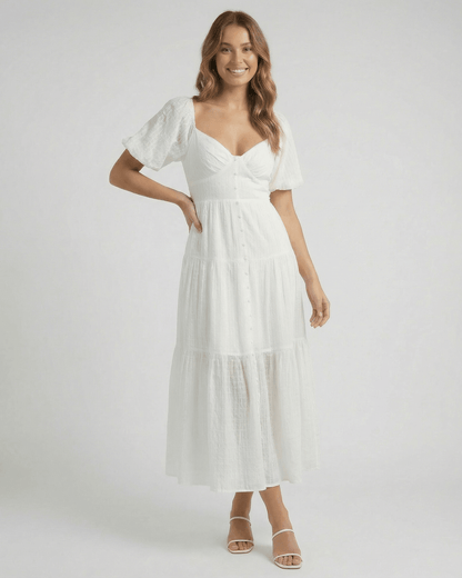 Elara Midi Dress by Lauven – Elegant white A-line silhouette with puff sleeves and button detailing.
