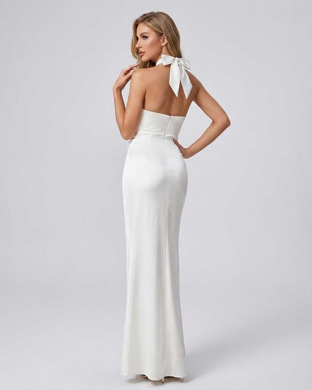 Elysia Maxi Dress by SLIMONA, elegant solid white halter neck bodycon dress from the back with stylish bow detail.