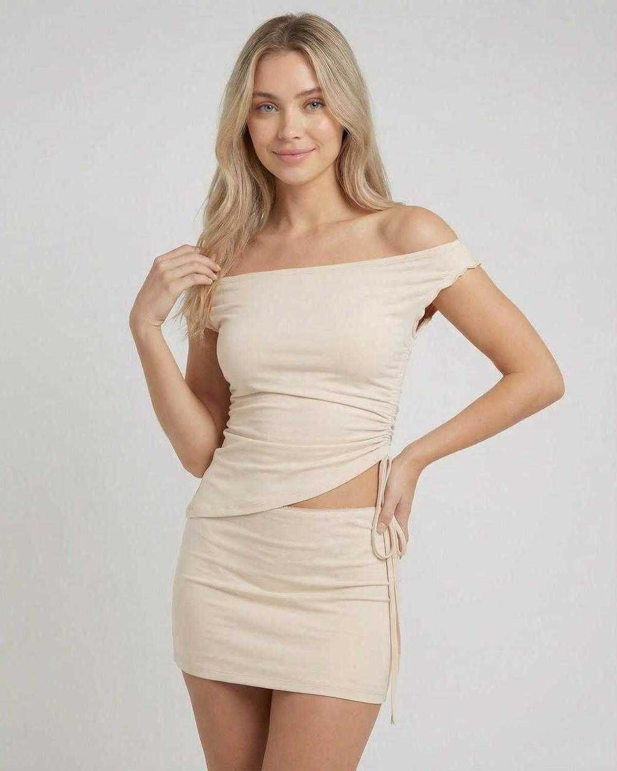 Elysia Mini Dress by Lauven featuring asymmetric off-shoulder top and high waist mini skirt in a neutral tone.