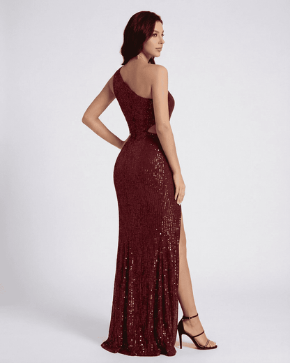 Stylish model showcasing the Ember Maxi Dress by SLIMONA with a one-shoulder design and shimmering sequin details.