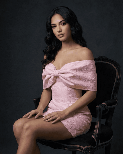 Fiora Mini Dress by SLIMONA in soft pink with off-the-shoulder bowknot design, showcasing A-line silhouette.