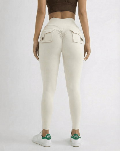 Model wearing Iris Leggings Cream by SLIMONA from the back, showcasing pockets and a sleek fit.