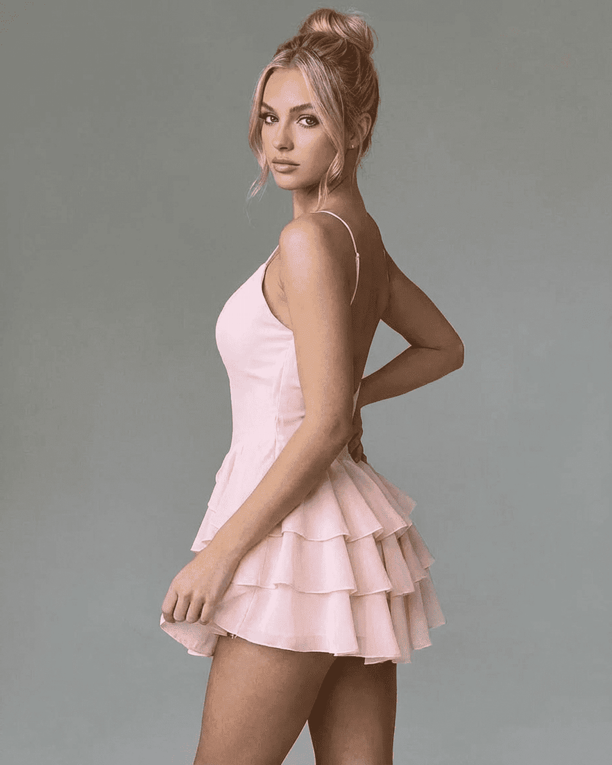 Isolde Mini Dress by SLIMONA in soft pink, featuring ruffle skirt and adjustable spaghetti straps, ideal for parties.