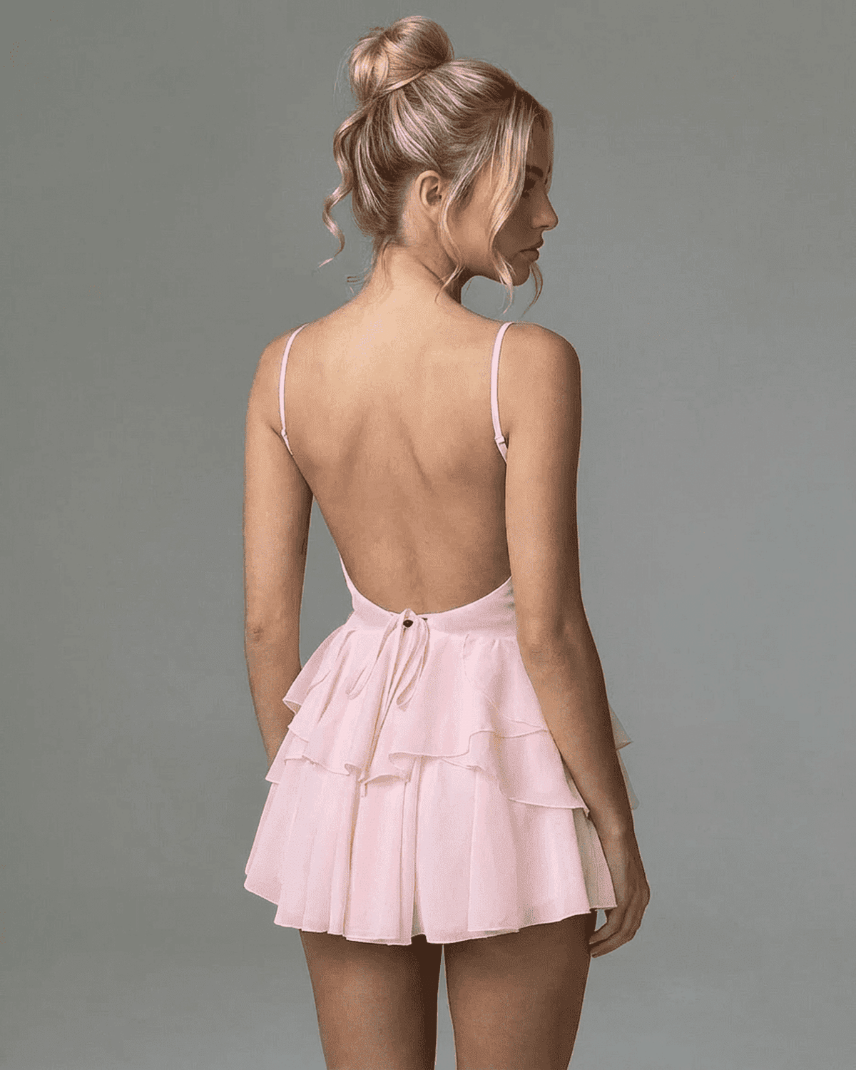 Isolde Mini Dress by SLIMONA featuring a plunging V-neckline and layered ruffle skirt in soft pink.