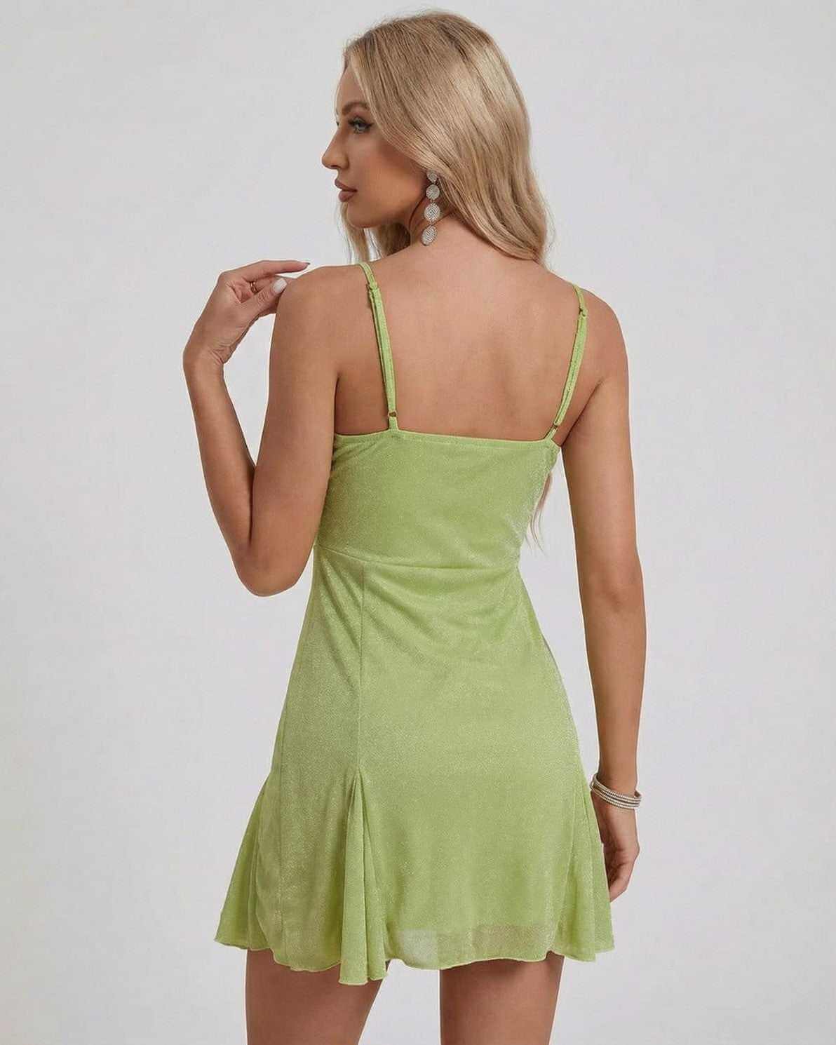 Back view of Ivy Mini Dress by Lauven, showcasing its A-line silhouette and shimmering light green fabric.