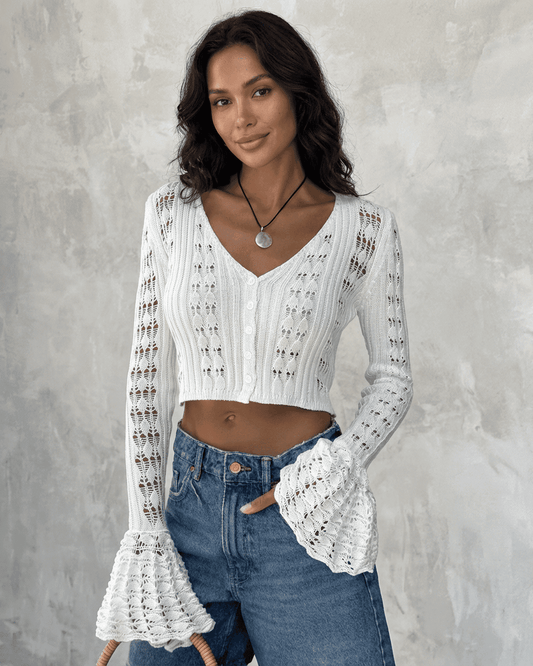 Model wearing Laceflare Cardigan by SLIMONA, featuring elegant lace details and dramatic flare sleeves.