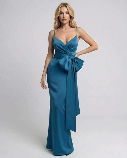Laguna Maxi Dress by SLIMONA, asymmetrical teal dress featuring a statement bow and sleek slip-style neckline.