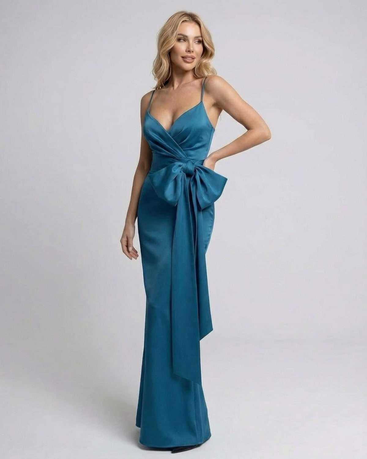 Laguna Maxi Dress by SLIMONA - Asymmetrical sleeveless design with dramatic bow detail in solid teal.