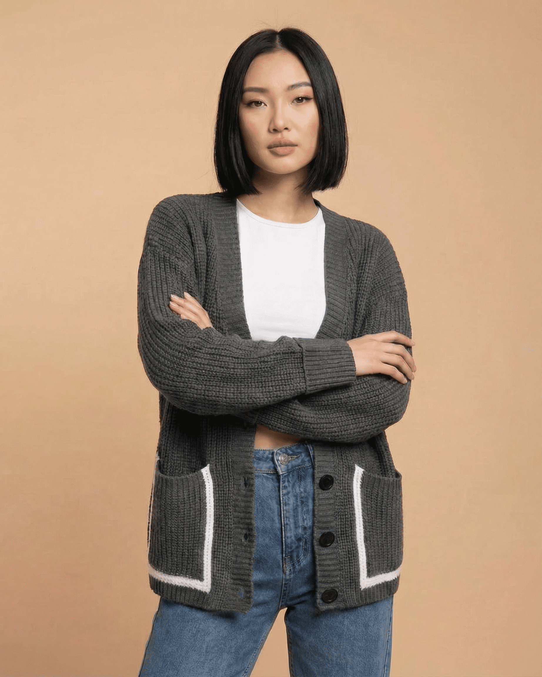 Linden Cardigan by SLIMONA on a model, showcasing relaxed V-neck style with pockets and button-front closure.