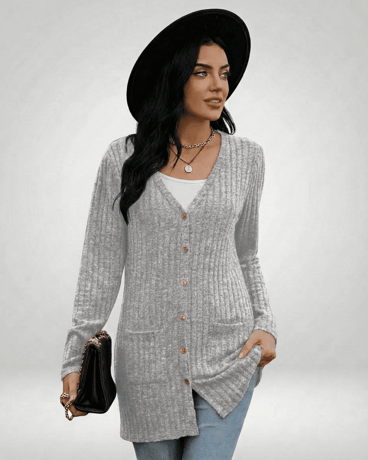 Woman wearing a stylish Luna Cardigan by SLIMONA, featuring a grey ribbed texture and button-front design.