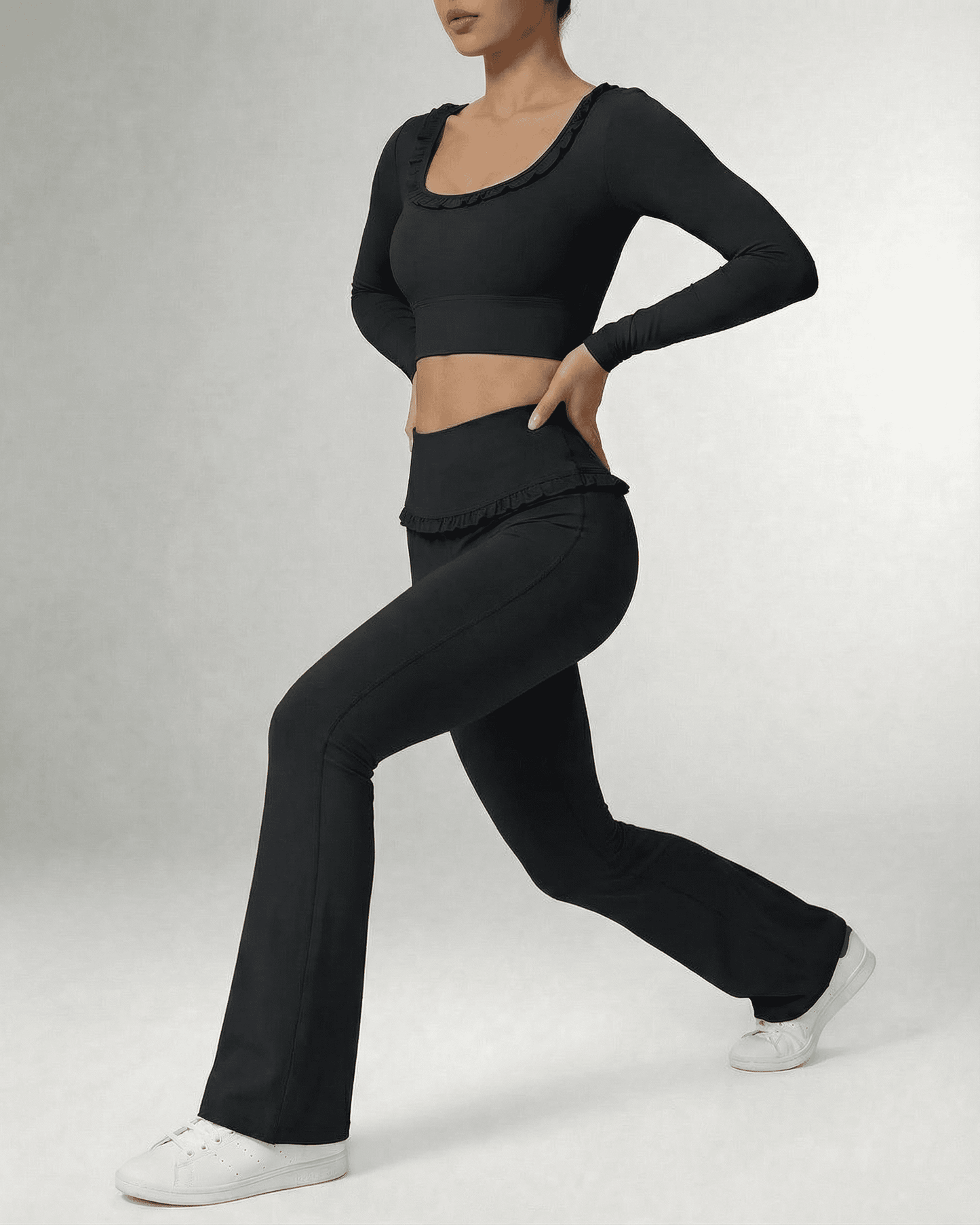 Model wearing Luna Leggings by SLIMONA, sleek black flare pants with a high-waist design and stylish top.
