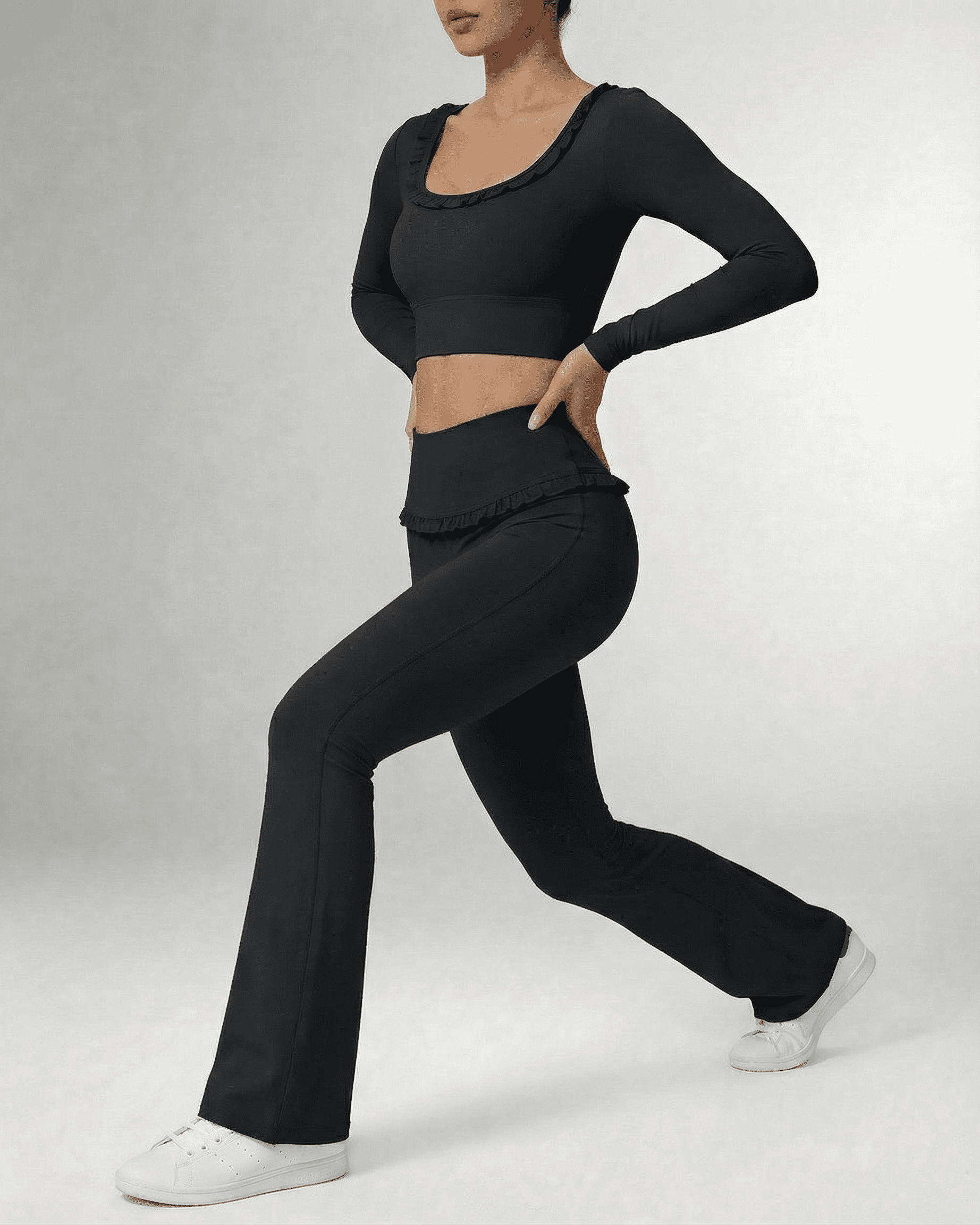 Model wearing Luna Leggings by SLIMONA, sleek black flare pants with a high-waist design and stylish top.
