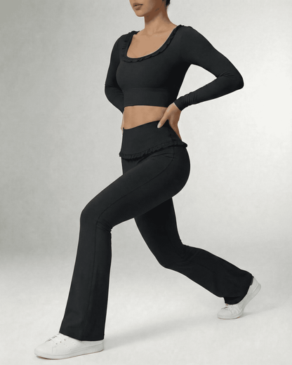 Model wearing Luna Leggings by SLIMONA, sleek black flare pants with a high-waist design and stylish top.