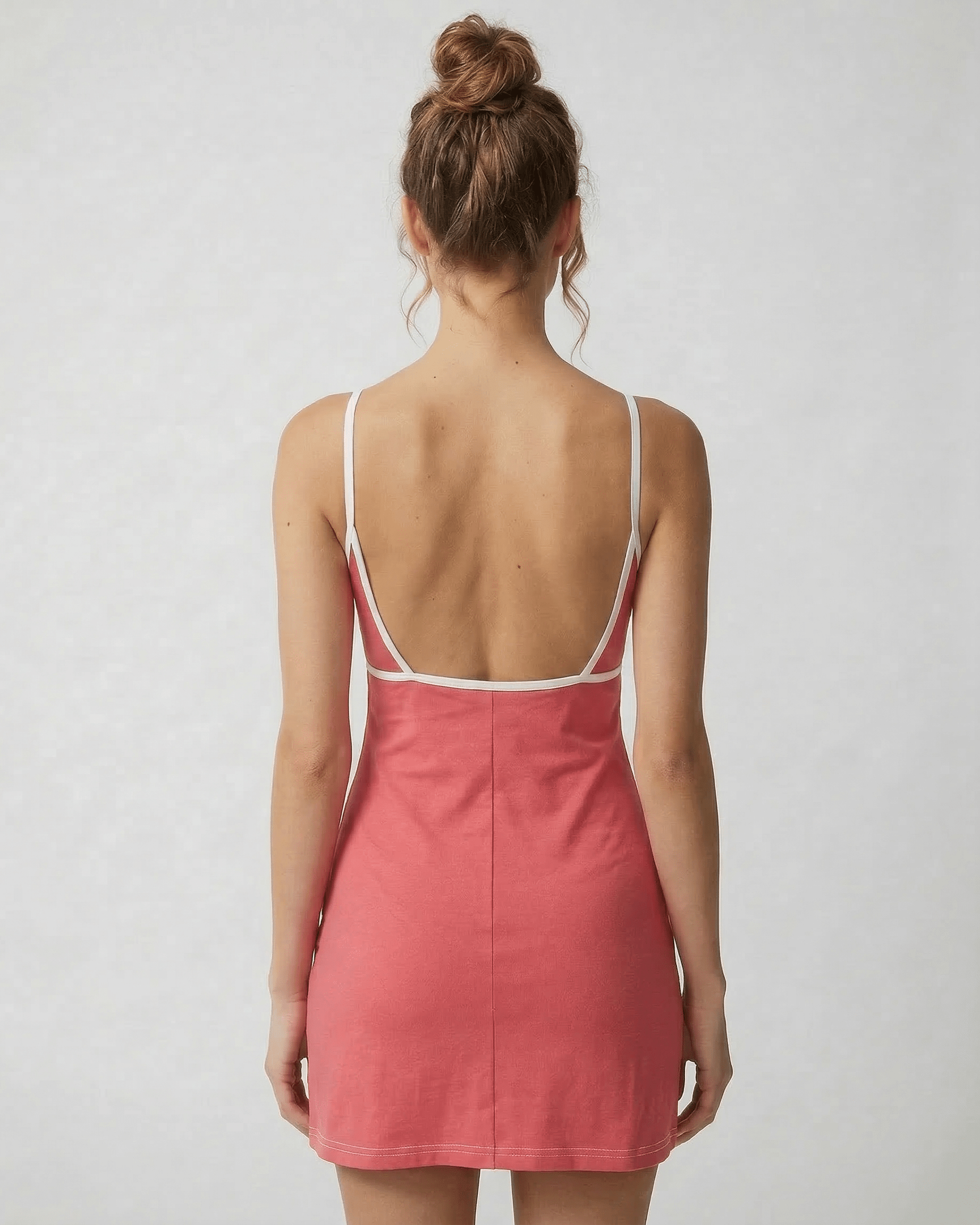 Back view of the Lauven Luna Mini Dress in vibrant pink, showcasing its cut-out detail and slim fit design.