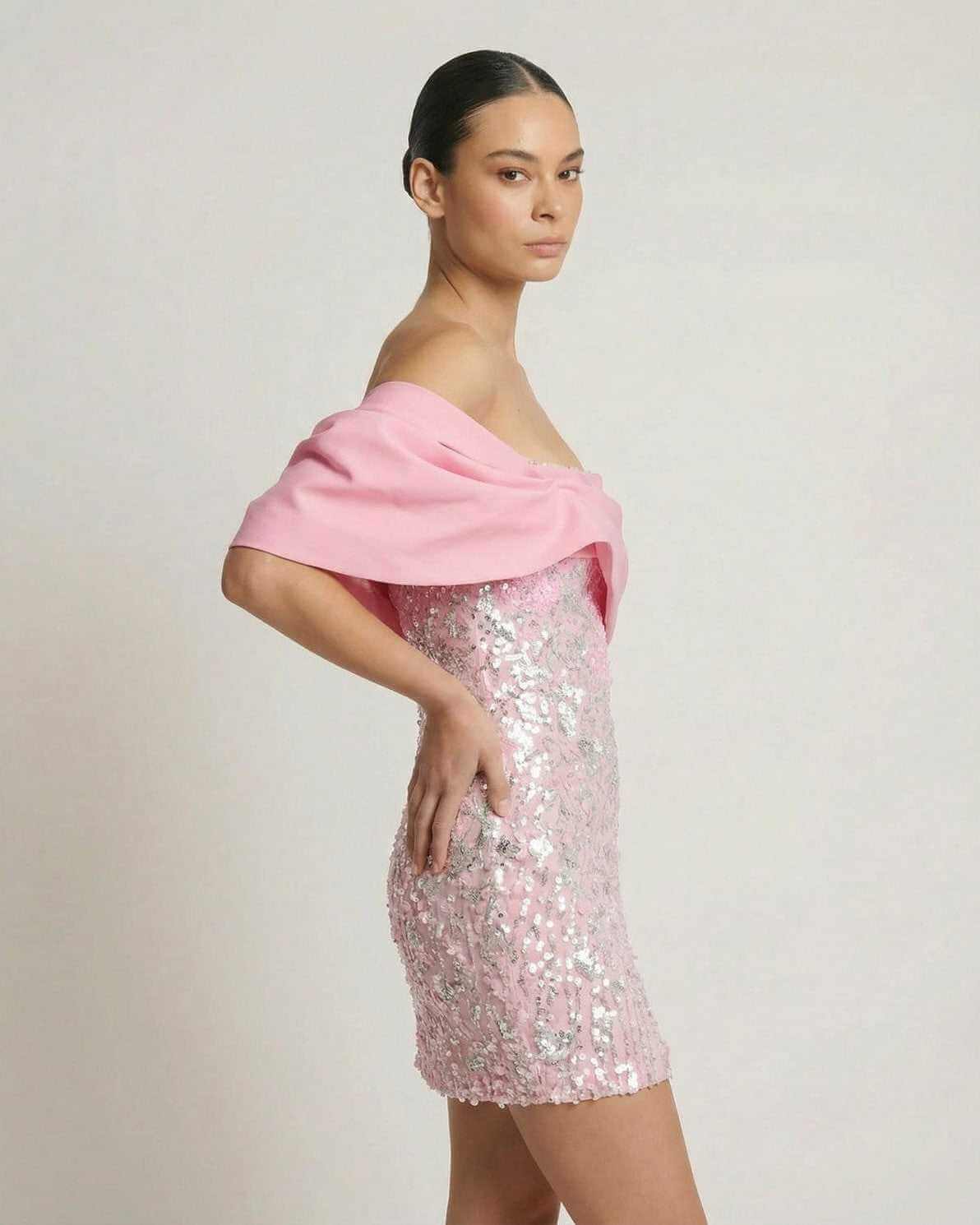 Lauven Luna Mini Dress featuring pink sequins and off-the-shoulder design, perfect for a glamorous party look.