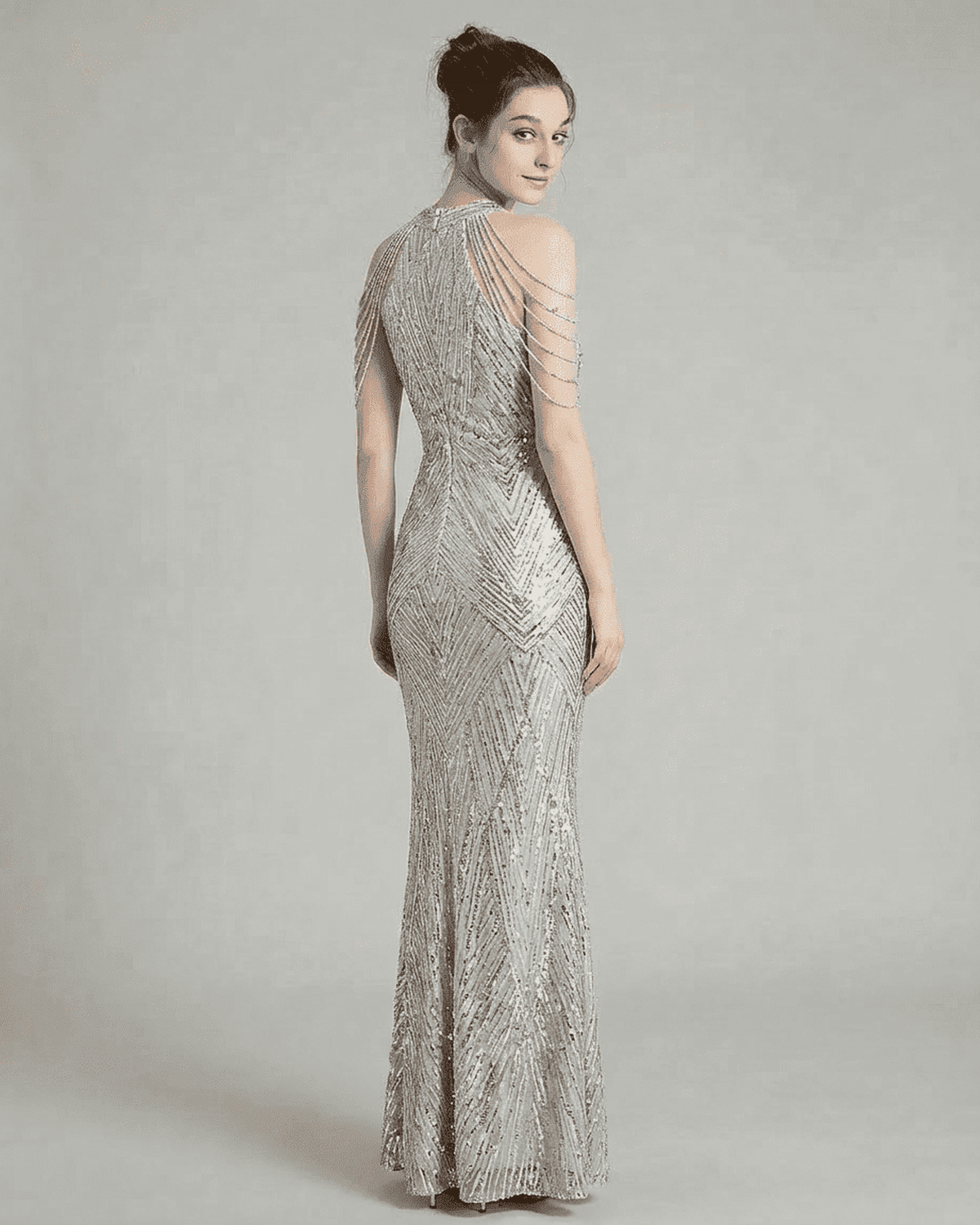 Luxe Maxi Dress by SLIMONA, showcasing a silver sequined halter gown with elegant beaded shoulder drapes.