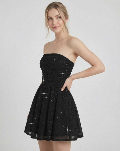 Lyra Mini Dress by SLIMONA, strapless black A-line dress with bow detail and shimmer finish.