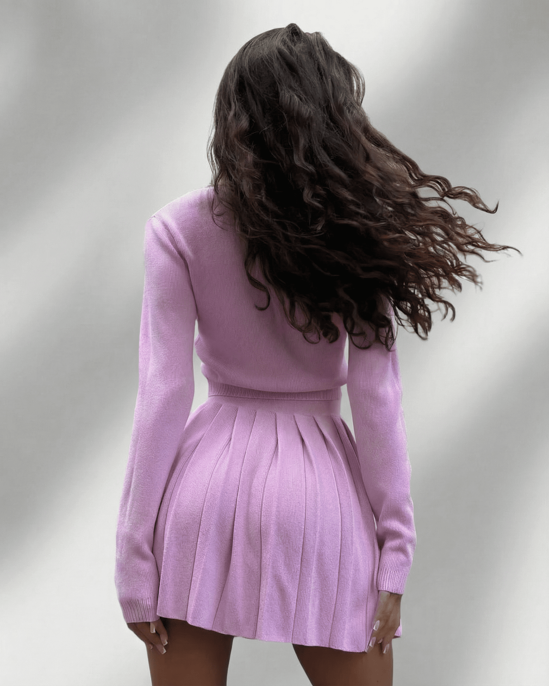 Lyra Two-Piece Set by SLIMONA featuring a soft knit cardigan and pleated mini skirt in pastel pink.