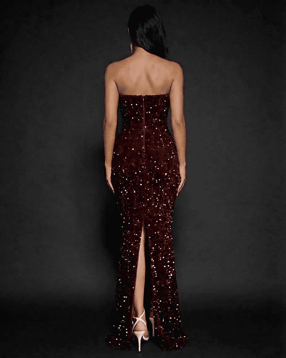 Back view of the Marquise Maxi Dress by SLIMONA featuring sequins, a dramatic thigh-high slit and strapless design.