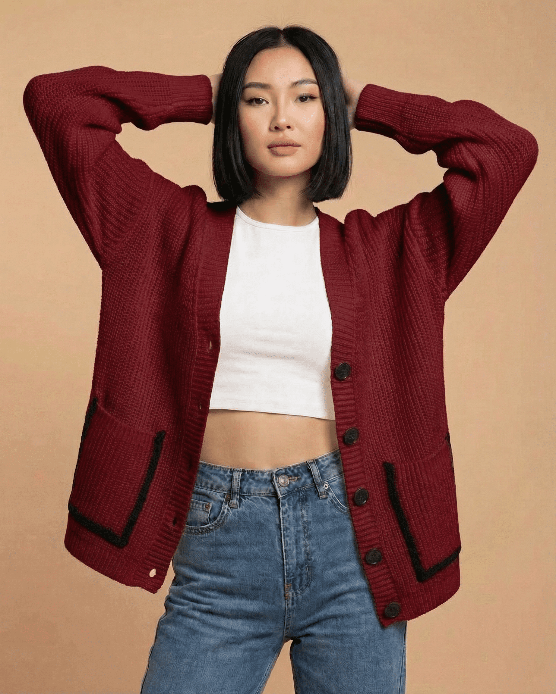 Model showcasing the Merano Cardigan by SLIMONA, featuring a loose fit and V-neck in a stylish burgundy color.