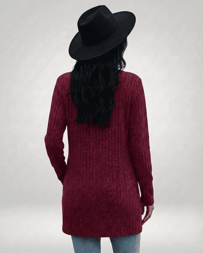 Back view of a woman wearing a SLIMONA Merlot Cardigan with a hat, showcasing its longline silhouette and textured knit.
