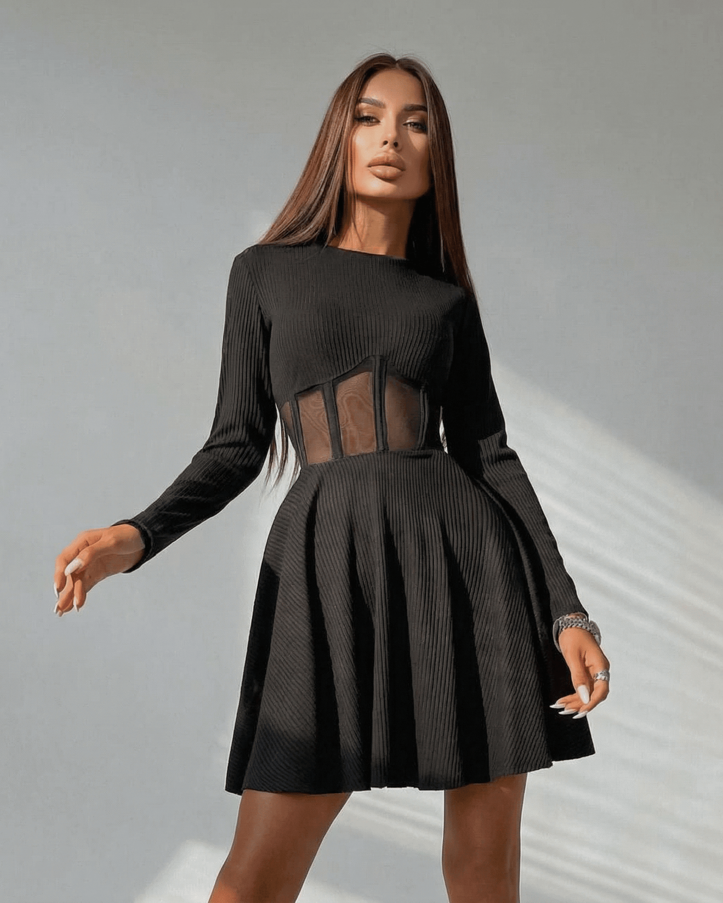 Lauven Monaco Mini Dress in black, featuring long sleeves and sheer corset panel, showcasing a stylish A-line silhouette.