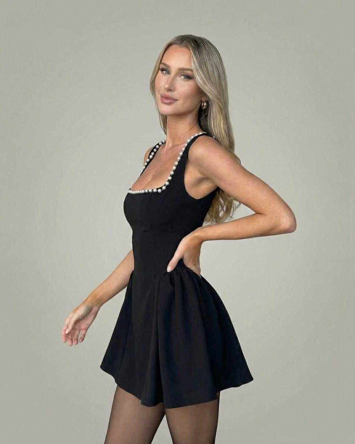 Monaco Mini Dress by Lauven featuring a sleek square neckline with pearl accents, crafted in a smooth black fabric.
