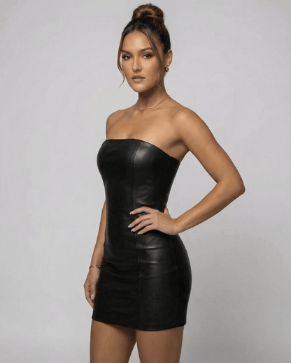 Model showcasing the Monaco Mini Dress by Lauven, a sleek strapless black PU pencil silhouette.