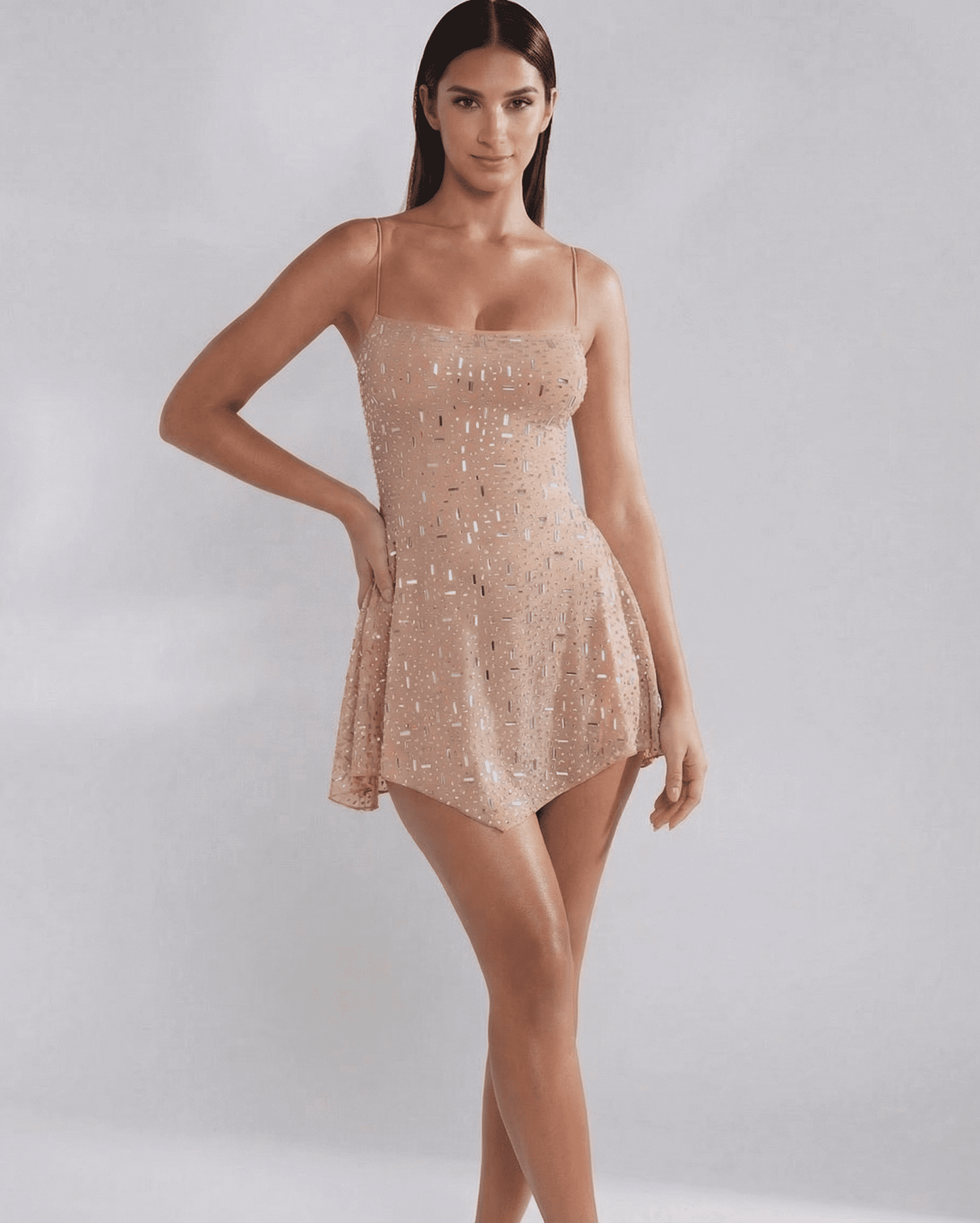 Monaco Mini Dress by SLIMONA, embellished mermaid-style mini dress in soft nude with square neckline and spaghetti straps.