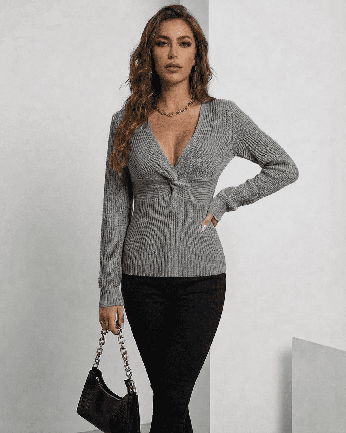 Nerina Pullover by SLIMONA, elegant grey V-neck ribbed sweater on model, perfect for layering in transitional seasons.