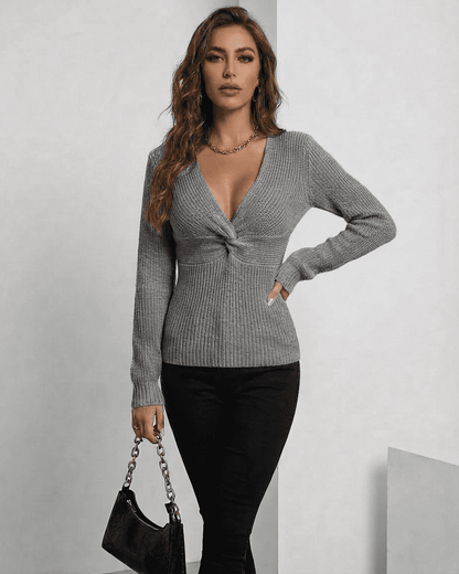 Nerina Pullover by SLIMONA, elegant grey V-neck ribbed sweater on model, perfect for layering in transitional seasons.