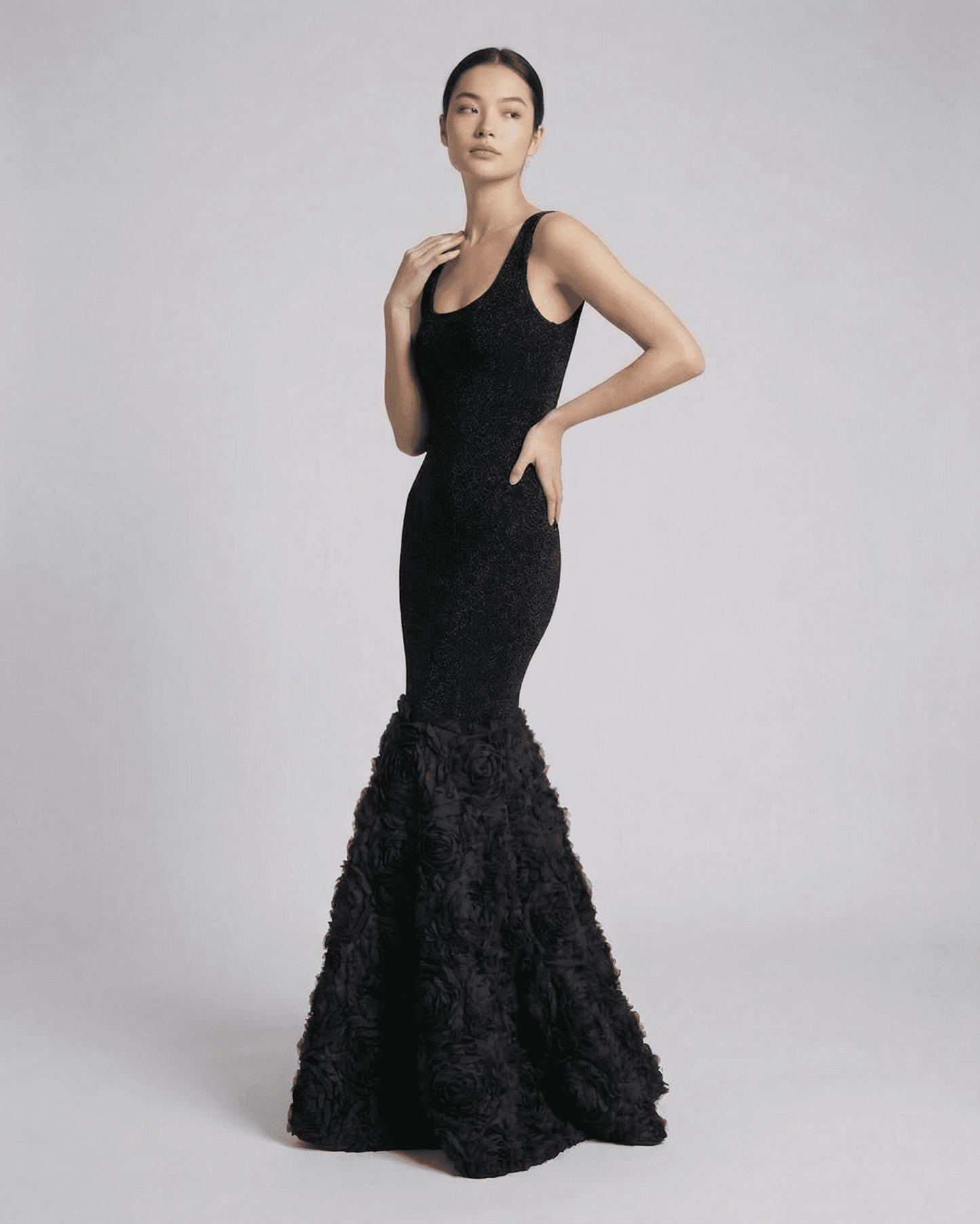 Nocturne Maxi Dress by SLIMONA — Elegant black gown with textured hem detail, showcasing a sleek silhouette.