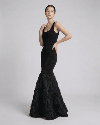 Nocturne Maxi Dress by SLIMONA — Elegant black gown with textured hem detail, showcasing a sleek silhouette.