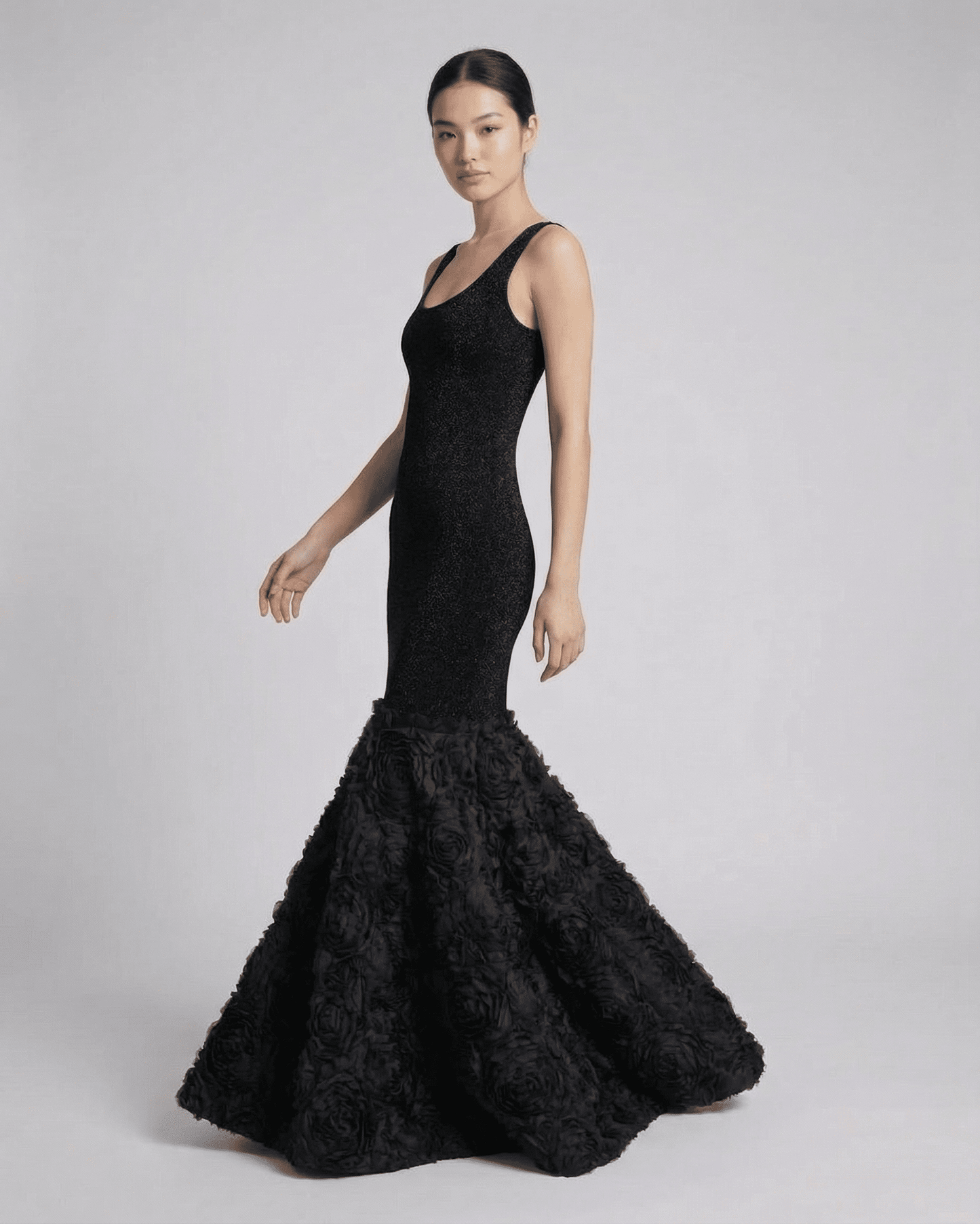 Nocturne Maxi Dress by SLIMONA featuring sculpted black silhouette with textured hem detail.