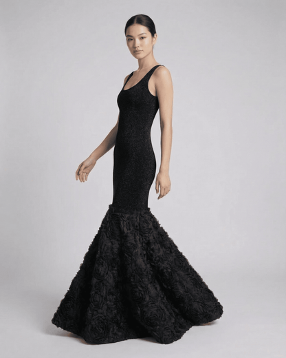 Nocturne Maxi Dress by SLIMONA featuring sculpted black silhouette with textured hem detail.