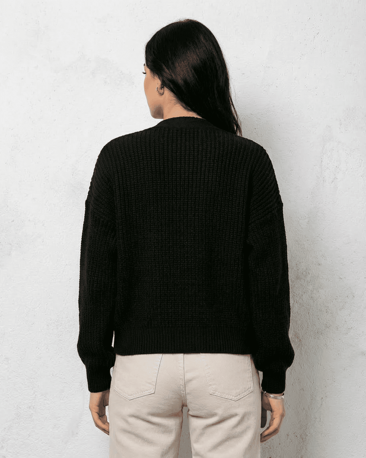 Back view of Noir Cardigan by SLIMONA, showcasing its cozy knit texture and classic cut.