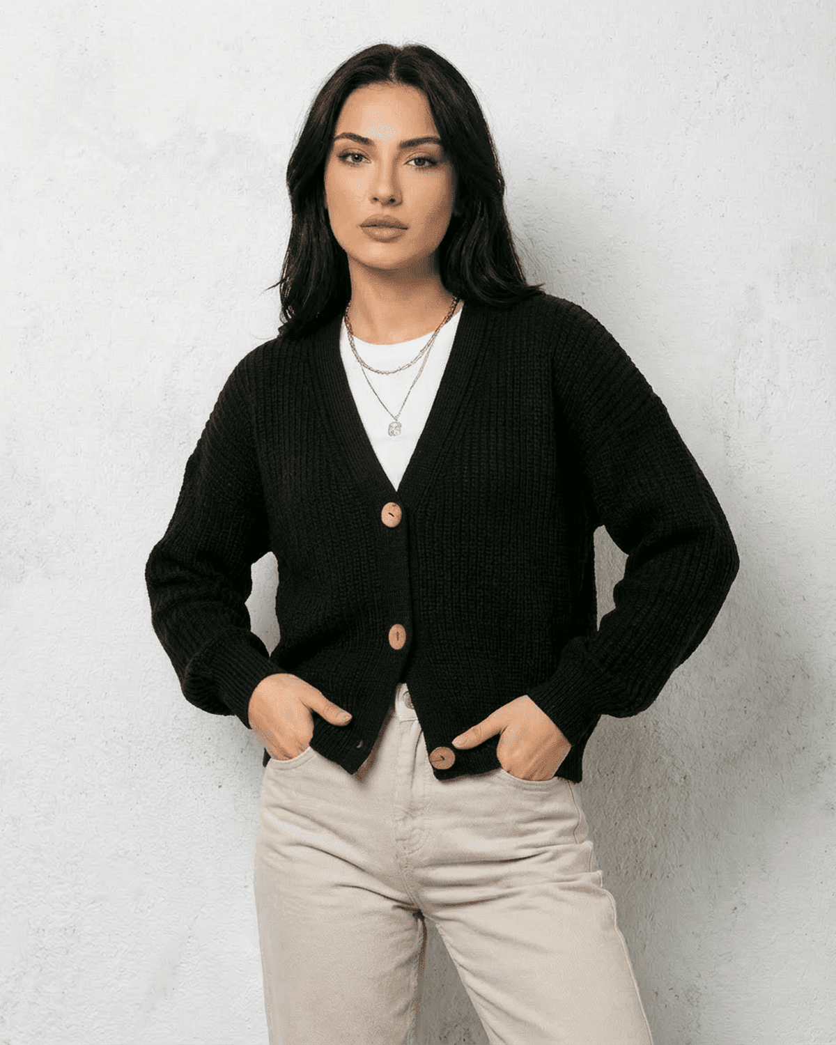 Noir Cardigan from SLIMONA - Stylish black knitwear with V-neck and button detail for a chic look.