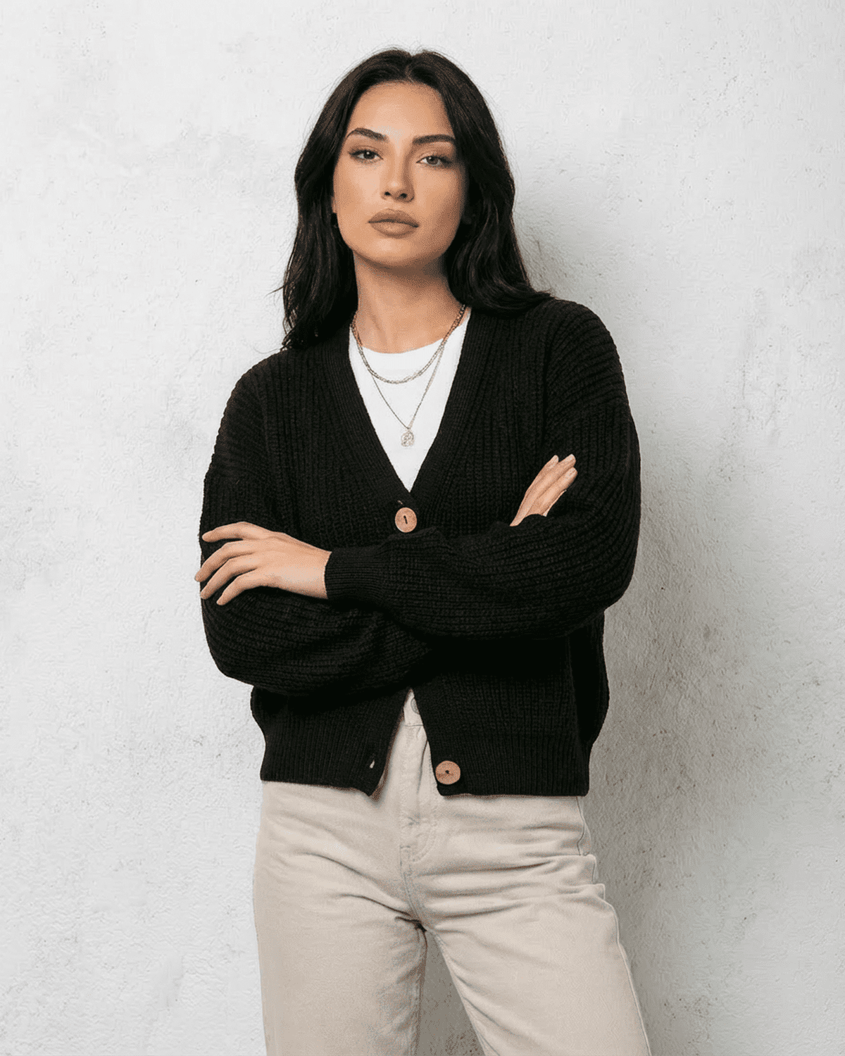 Noir Cardigan by SLIMONA, featuring a classic V-neck and button detail in sleek black knitwear.